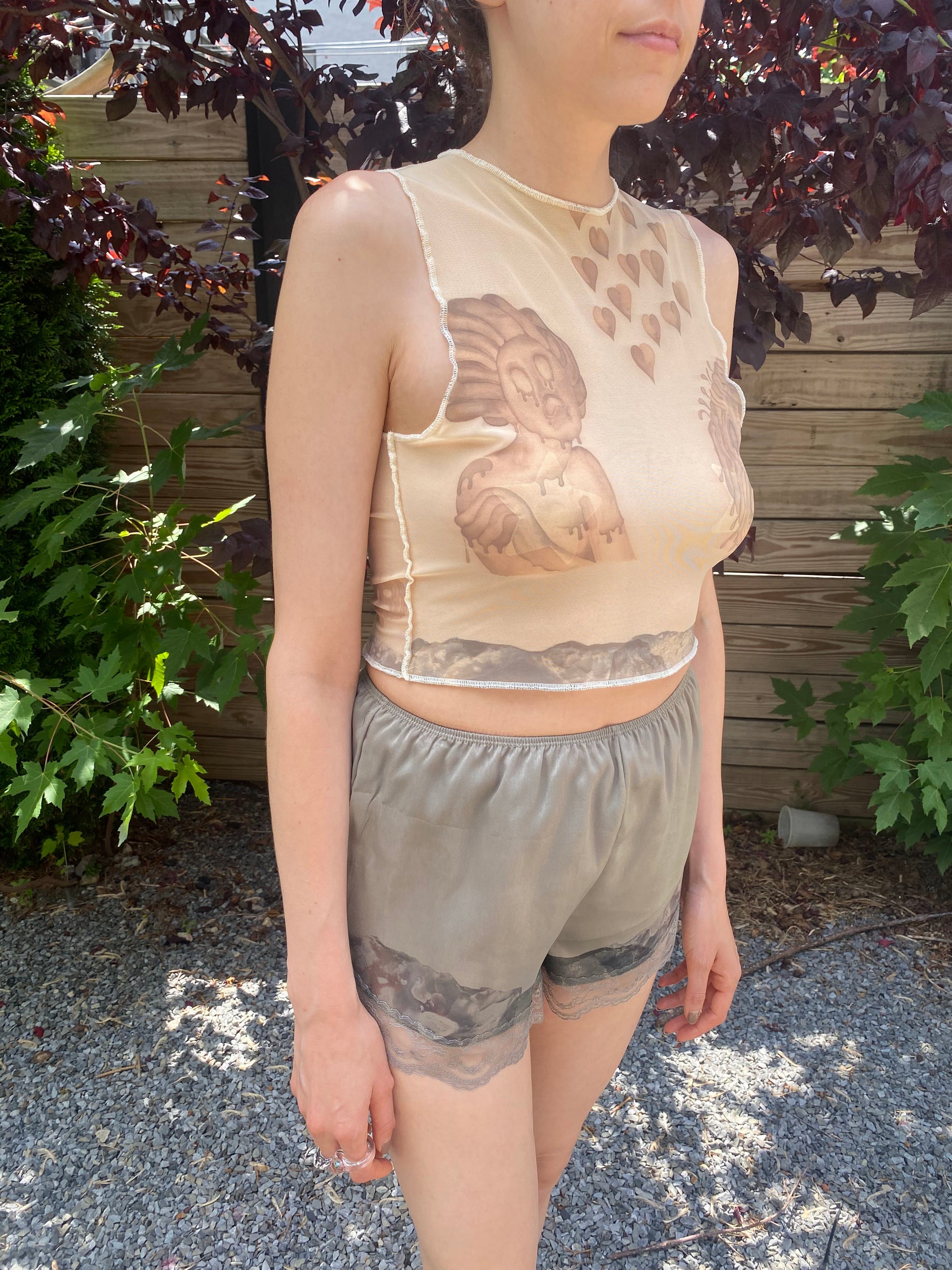 beige mesh crop top with despair faces print, 3/4 view