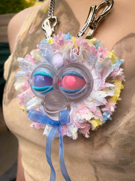 face pendant with opal and rose quartz eyes and lace ruff, 3/4 view