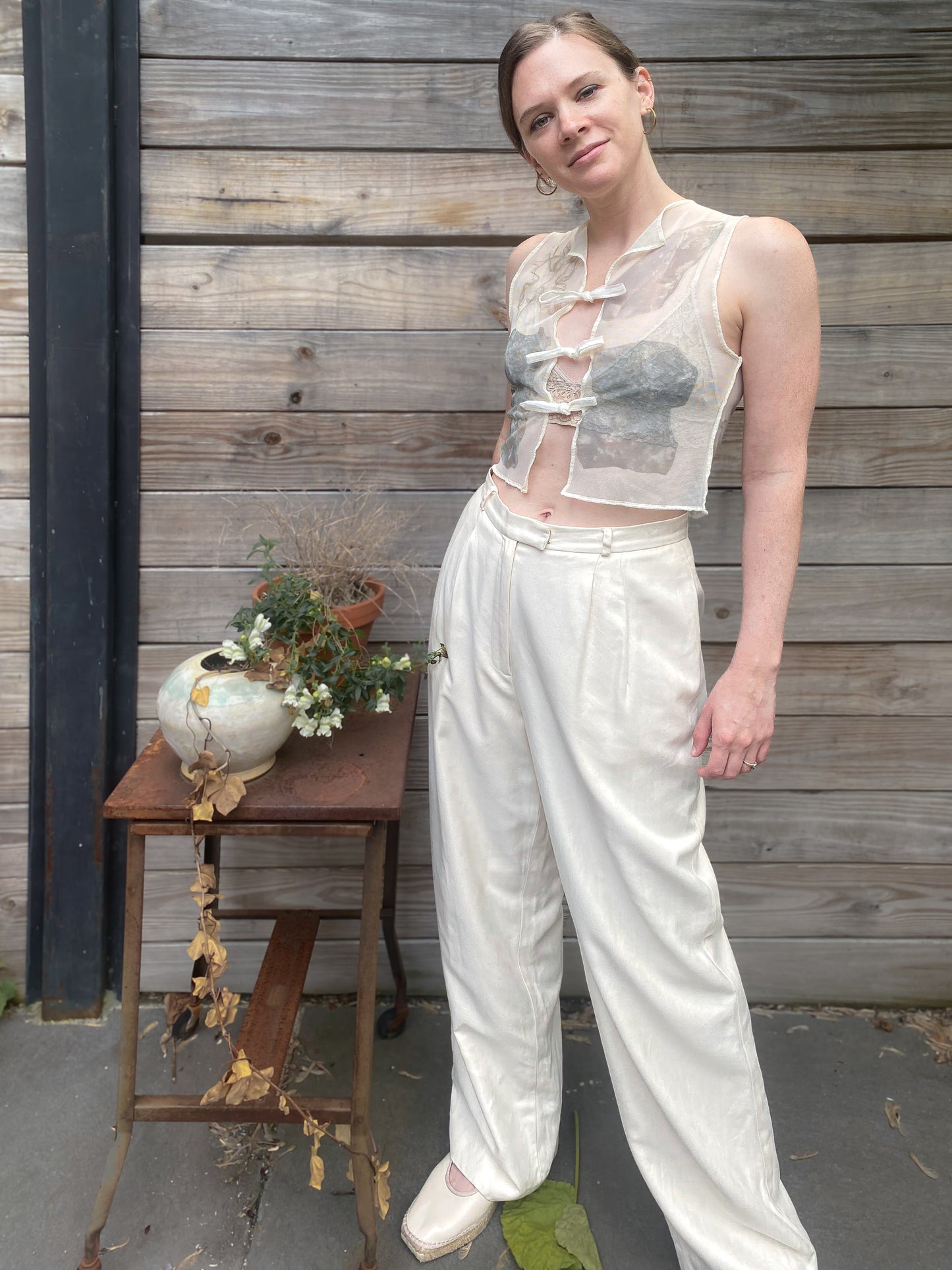 model wears white mesh vest with rock print